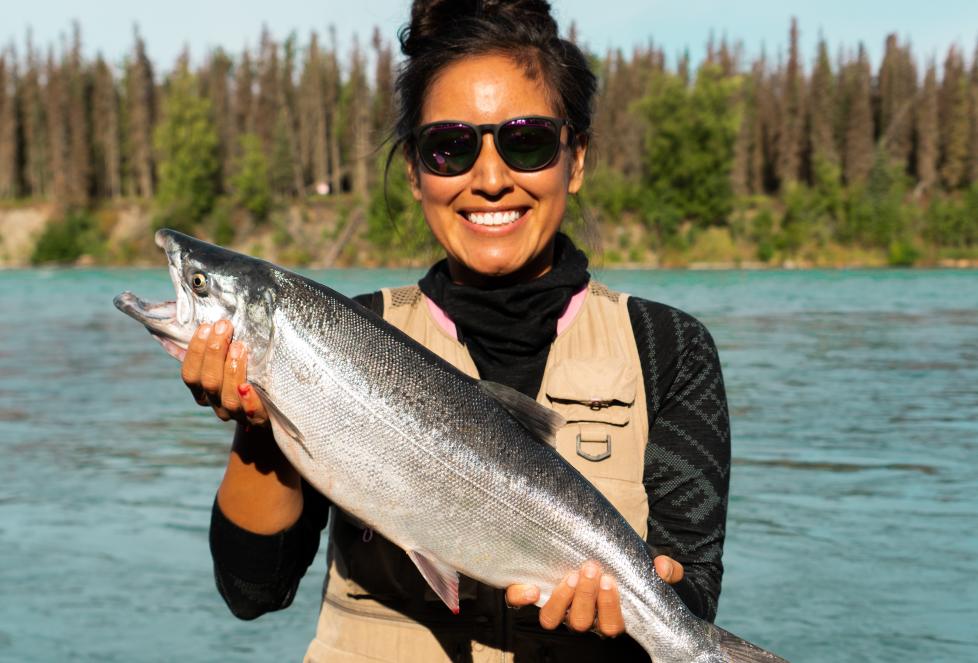 Woman smiling and holding large fish