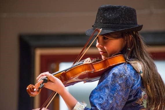 Sherman Hogue / Explore Fairbanks a young Alaska native woman playing a violin