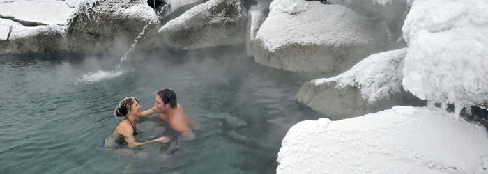 Two people in pool at Chena Hot Spring Resort during winter