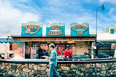 A person walking in front of an Alaskan restaurant
