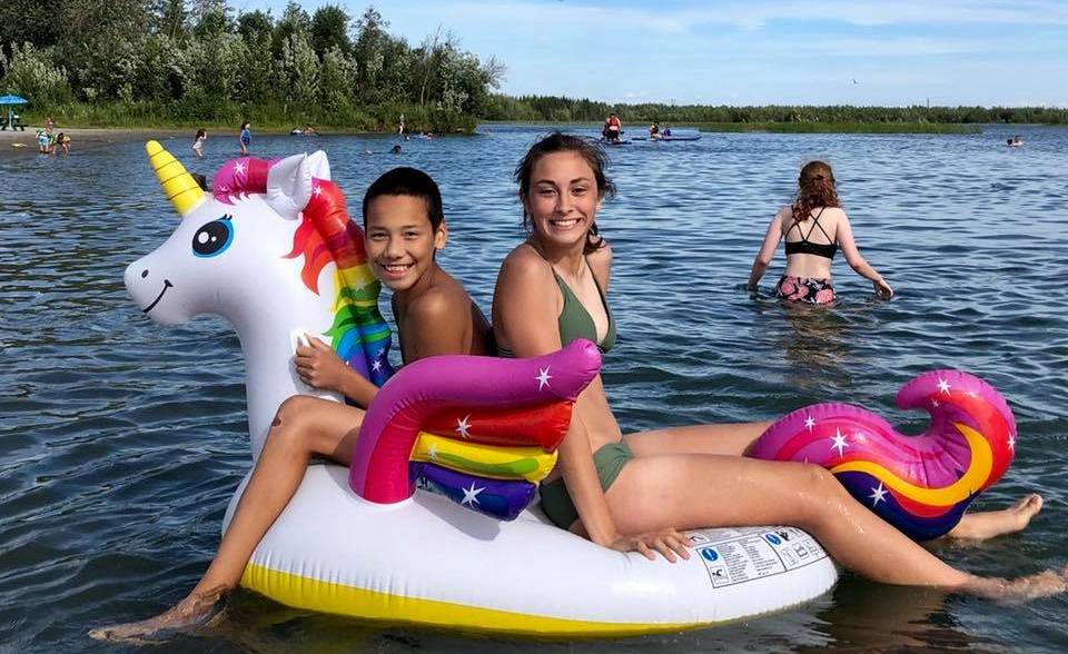 Kids floating on unicorn inner tube at Tanana Lakes