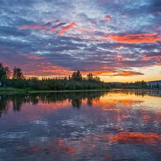 A sign that reads LOVE ALASKA during a sunset along the Chena River