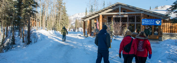 People in front of small building at Denali winterfest 