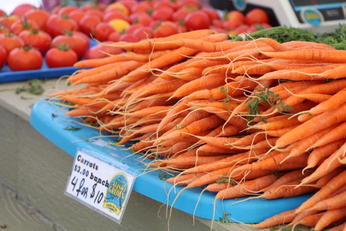 Bill Wright | Explore Fairbanks close up of orange carrots for sale at Farmers Market