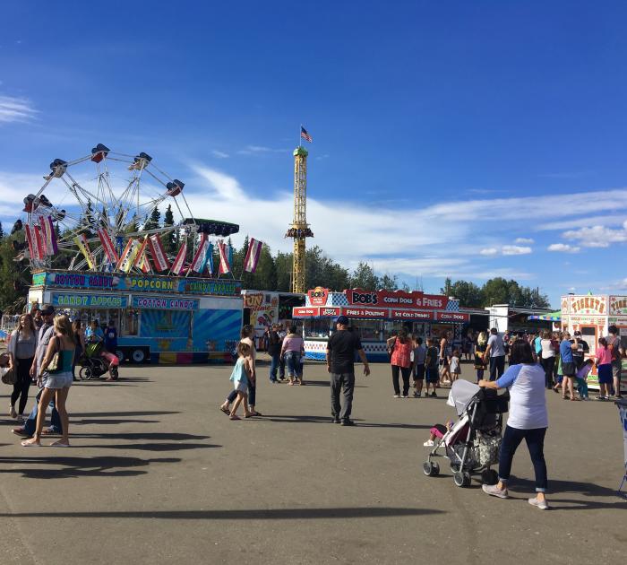 Amy Geiger | Explore Fairbanks people milling about at a midway of a state fair