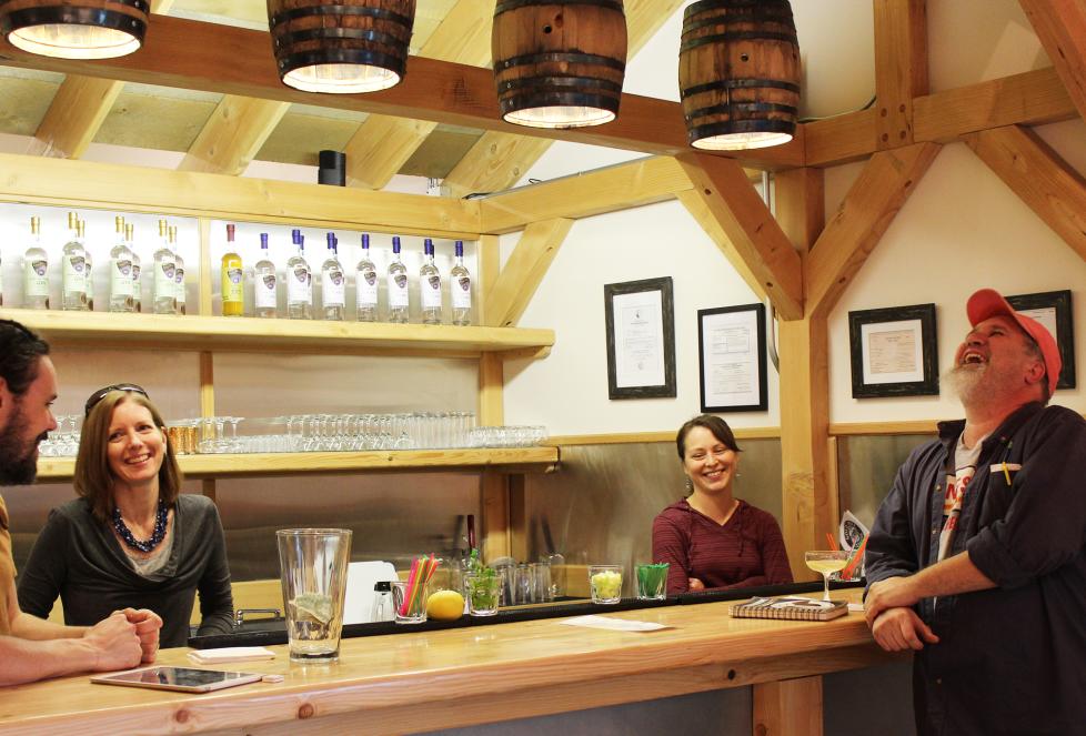 Patrons gathered around the bar at Ursa Major, laughing and enjoying their time together.