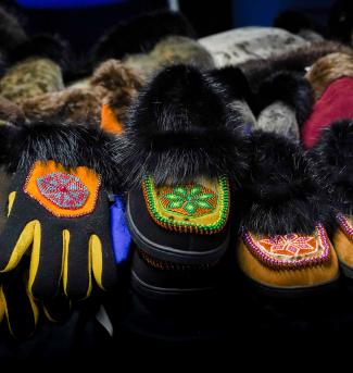An assortment of hand-crafted and beaded Alaska Native shoes and gloves.